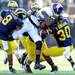 Michigan defense swarm Northwestern wide receiver Cameron Dickerson during the fourth quarter at Michigan Stadium on Saturday. Melanie Maxwell I AnnArbor.com